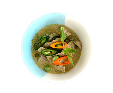 Thai green curry pork on bowl with white background