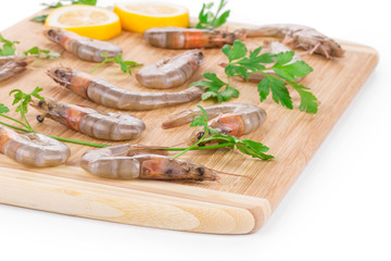 Fresh shrimps on wooden board.