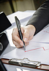 Businesswoman pointing to business chart