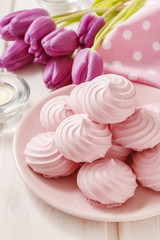 Obraz na płótnie Canvas Pink meringues on cake stand