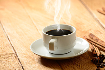 Coffee cup with smoke and coffee beans around