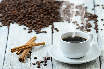 Coffee cup with smoke and coffee beans around