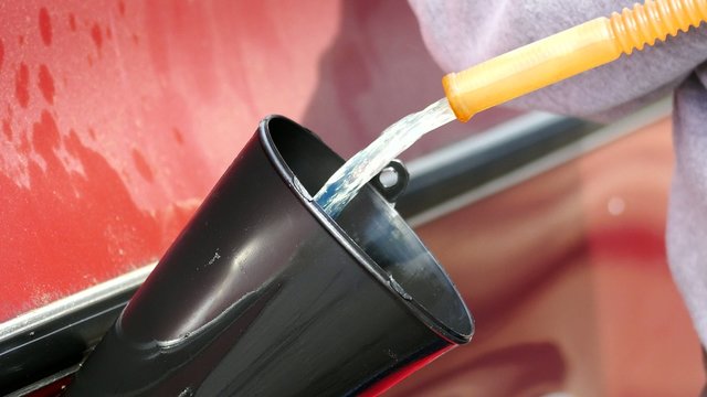 Gas Being Poured Down A Funnel