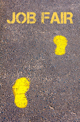 Yellow footsteps on sidewalk towards Job Fair message