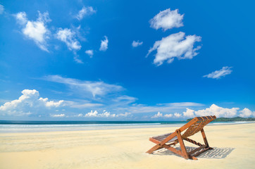Fototapeta na wymiar Chair under blue cloudy sky at koh Payam , Ranong , Thailand