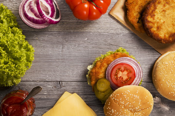 Chicken burger with cheese, lettuce, tomato and onion