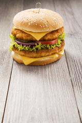 Chicken burger with cheese, lettuce, tomato and onion