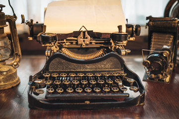 vintage photography still life with typewriter, folding camera,