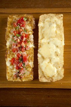 Toasted open faced salsa and egg sandwich with melted mozzarella