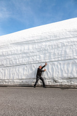 highway along the snow wall. Norway in spring