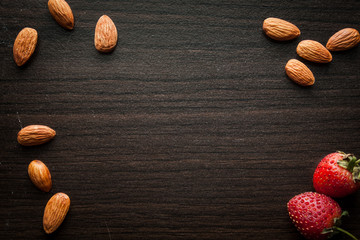 Almond and strawberries wood background