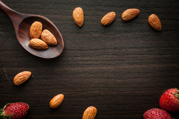 Almond and strawberries wood background