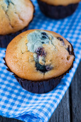 Blueberry muffins on wooden table