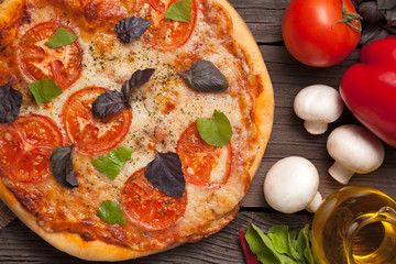 Traditional pizza margherita with tomatoes, pepper and olive oil