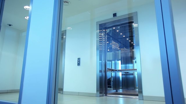 Elevator door opens into the hall of an office building
