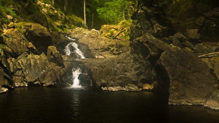 Detail of rocks with small waterfall at Black river gorge