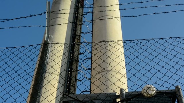 barbed fence - chimney in background