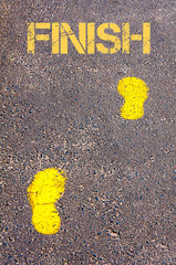 Yellow footsteps on sidewalk towards Finish message