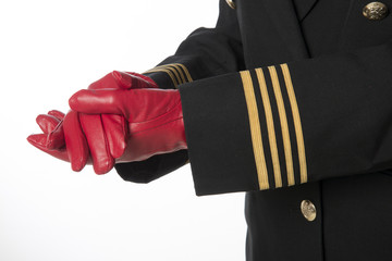 Gold rings on airline officers uniform Clenched hands in gloves