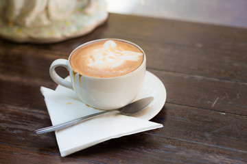 Cup of coffee on wooden table