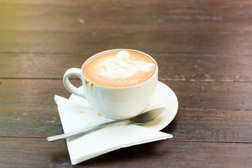 Cup of coffee on wooden table