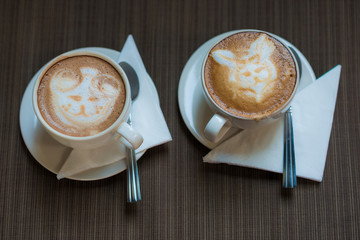 Two cups of coffee cappuccino on table