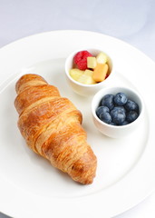 Breakfast with croissants and fruit