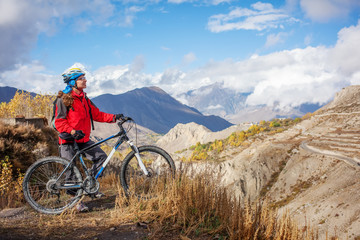 Fototapeta na wymiar Biker-girl in Himalaya mountains, Anapurna region