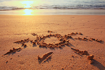 drawing on the sand sea surf