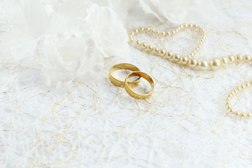 Two golden wedding rings with seamless flower decorations