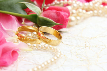 pair of wedding rings with roses for background image