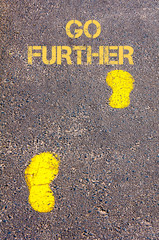 Yellow footsteps on sidewalk towards Go Further message