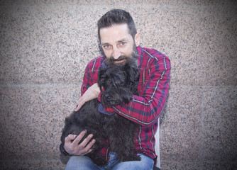 bearded man sitting with dog