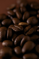 Roasted coffee beans on the brown background