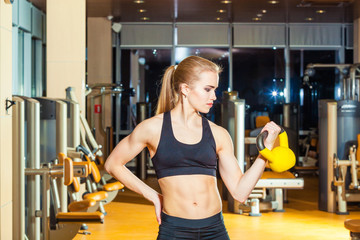 Fototapeta premium Fitness woman exercising crossfit holding kettlebell strength