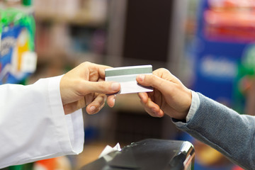 Hand of customer giving credit card at checkout