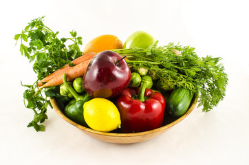 Composition of fresh fruits and vegetables in wooden bowl
