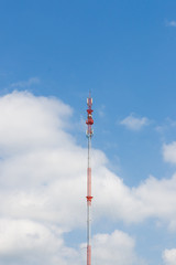 Outdoor tele communication red and white tower blue sky and clou