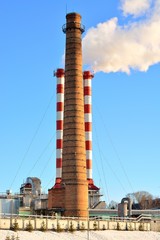 Boiler tube urban winter against the blue sky