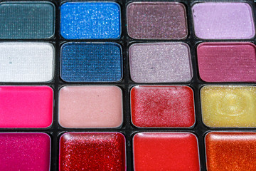 Close up of eye make up and blusher in various colors.