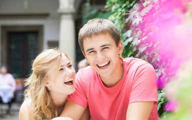 Happy couple having a great time talking over a cup of coffee