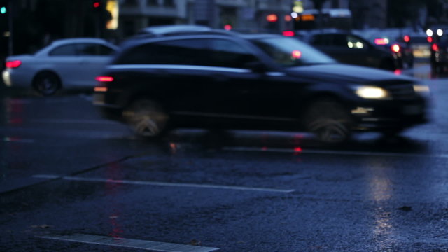 Wet asphalt, cars and light reflections