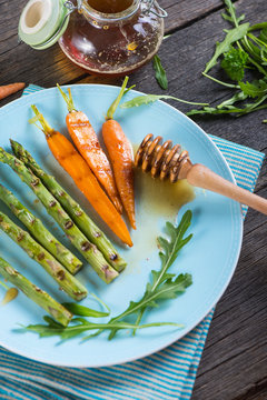 colorful spring healthy dish with grilled carrots and asparagus