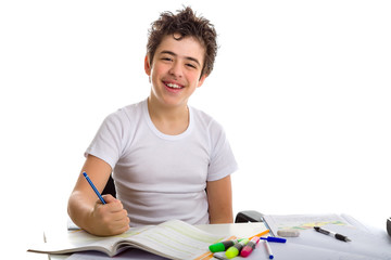 Fototapeta na wymiar teenager boy on homework smiling and writing