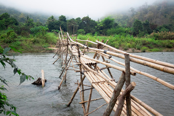 Fototapeta na wymiar Bamboo bridge over a river in province of Pai Mae Hong Son, Thai