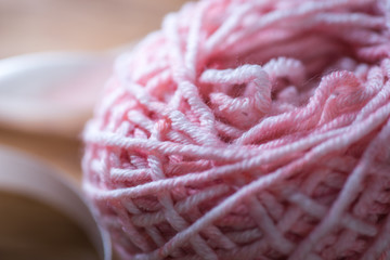Ball of pink knitting yarn with ribbon