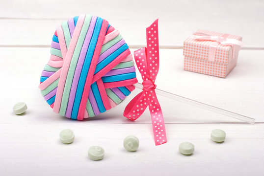 multi-colored heart with ribbon and mint candy.
