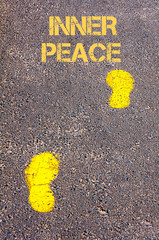 Yellow footsteps on sidewalk towards Inner Peace message