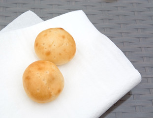 Two small buns on white napkins.