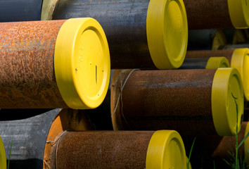 Construction tubes with yellow lids and rust.